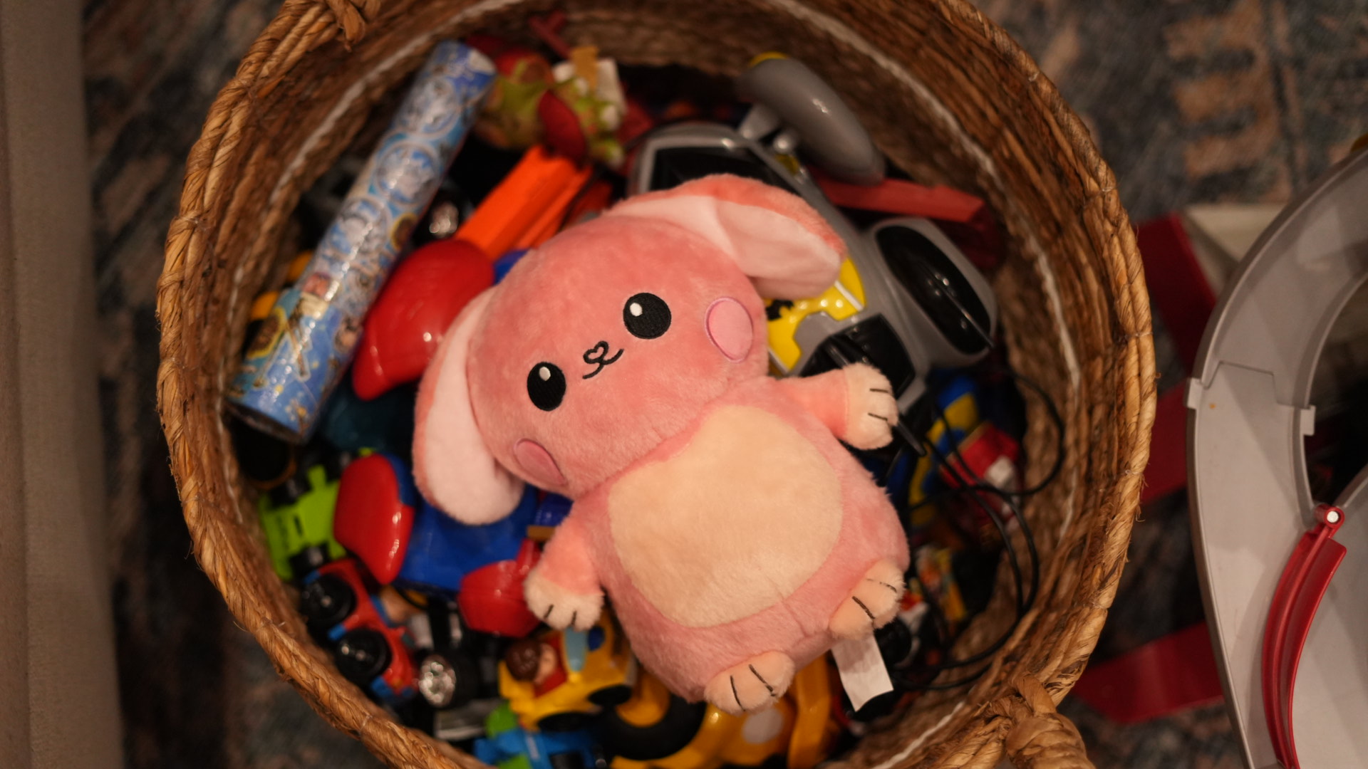 Glow Buddy resting in a basket of toys.