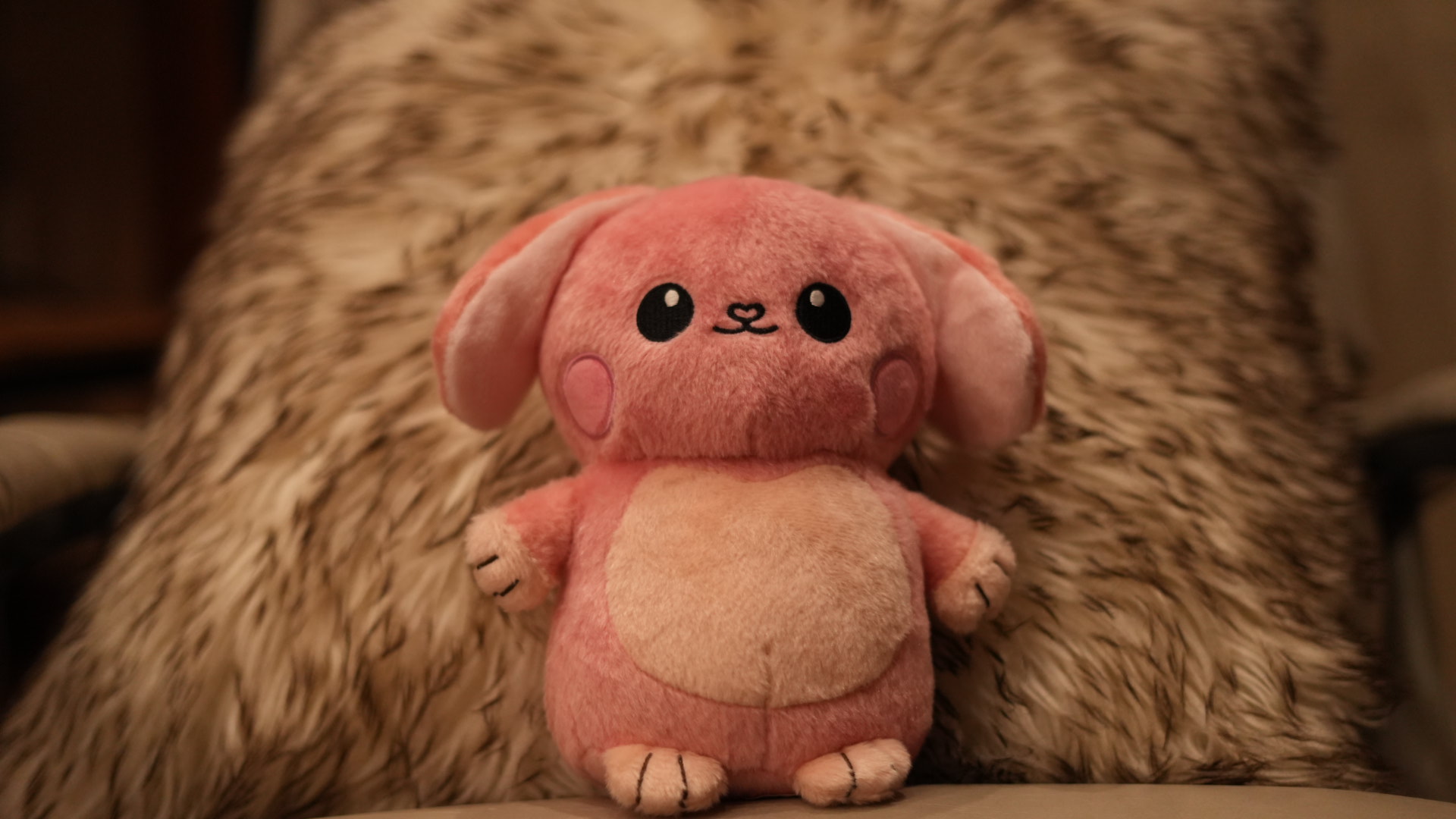 Glow Buddy sitting against a soft blanket.
